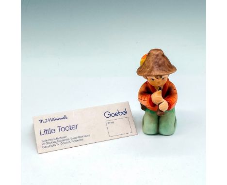 Matte finished kneeling figural with instrument. Colored in brown, orange and green. Goebel backstamp. 214H. This item has it