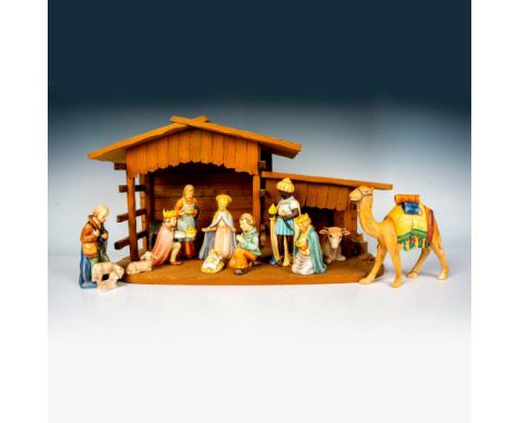 Hand painted porcelain figures and a wooden display inn. Figurines includes the infant Jesus, Joseph, Virgin Mary, the Three 