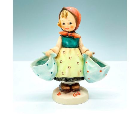 Matte finished figurine features a girl holding two bags. Goebel backstamp. M.I. Hummel impressed mark 175. This item has its