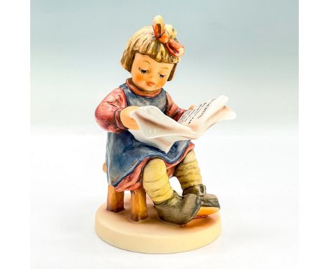Hand painted figure of a young girl sitting on a stool holding a magazine, reading. Exclusive Edition. Goebel backstamp. This