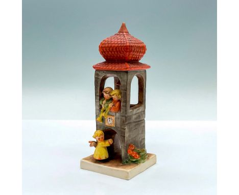 Hand painted figure of a clock tower with angels. Goebel Hummel marking. Issued: c. 1960-1972Dimensions: 3"L x 2.75"W x 6.5"H