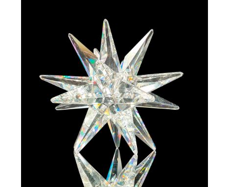 Faceted crystal candle stick holder modeled as a stunning starburst. Swarovski acid mark to base. Dimensions: 4"L x 4"W x 4"H