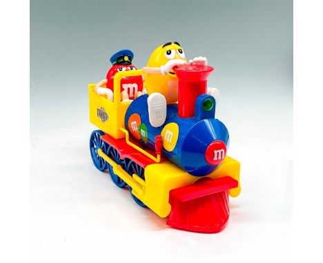 Multicolored plastic train colored in red, yellow, blue with yellow M&amp;M character on top with red character in rear train