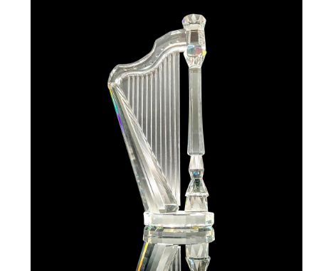 Sparkling faceted and molded crystal figurine modeled as a pedal harp. Swarovski acid marks. Dimensions: 2"L x 1"W x 4"HManuf