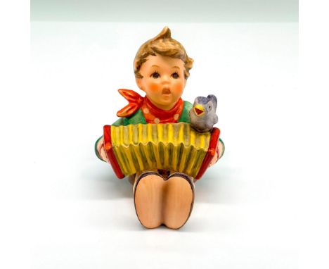 Figurine depicts a boy with an accordion and a bird. It has the Goebel backstamp on the bottom. Item comes with its original 