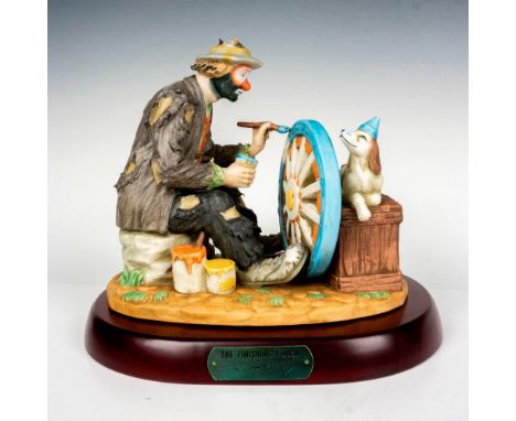 Limited edition, hand painted bisque porcelain depicting figural clown Weary Willie adding the last details to the wheel with