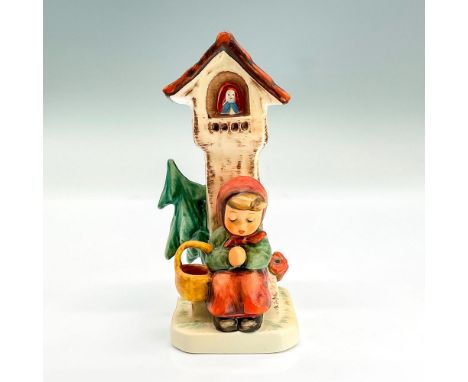 Hand painted figure of a young girl sitting in front of a tower with hands clasped in a prayerful pose. Goebel backstamp. Thi