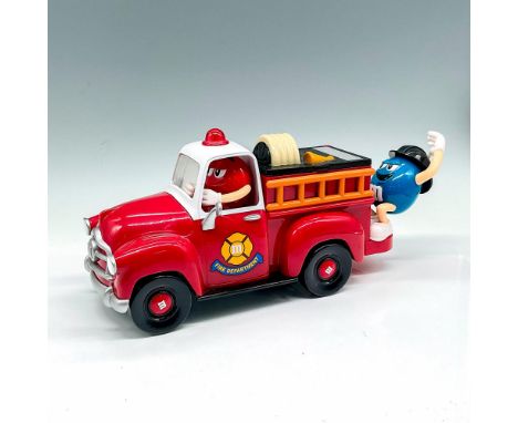 Red plastic truck with Fire Department emblem on doors, M's on hubcap and front grill with red M&amp;M character driving and 