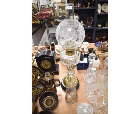 An impressive Victorian oil lamp, having etched glass globular shade, clear faceted reservoir and brass twist formed stem, on