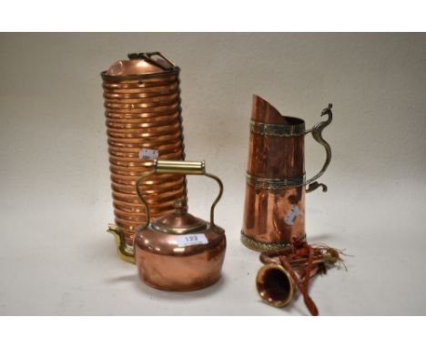 An early 20th century ribbed copper 'Kumfy' hot water bottle, a miniature copper kettle and horn and a pitcher with embossed 