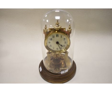 An early 20th century brass 400 day anniversary clock, having enamel face and glass dome, impressed to mechanism with Gustav 