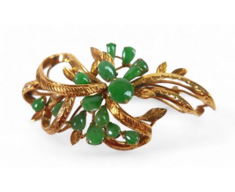 A 10k gold and jade spray brooch, the ribbon and leaf design set with fifteen cabochon jades in oval, round and pear shapes, 