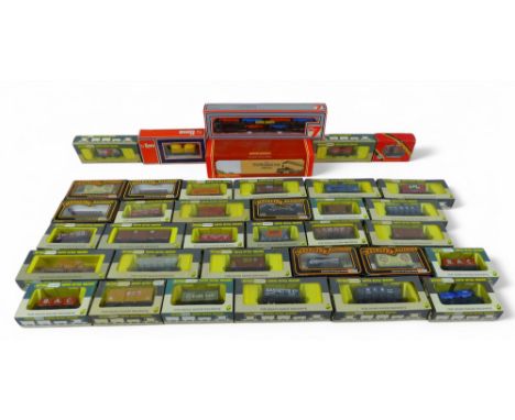 A collection of thirty five OO gauge railway rolling stock all boxed, including Lima, Wrenn, Mainline and Hornby. (1 box)