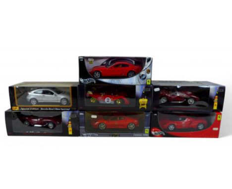A collection of seven 1:18 scale die cast boxed sports cars, including Shell, Maisto and Hot Wheels. (7)