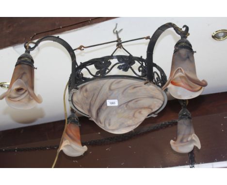 20th Century French black painted wrought iron light fitting with five mottled glass shades, the shades with etched signature