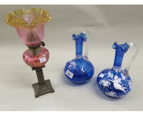 Pair of Victorian blue glass jug vases with white enamel decoration of cherubs and flowers, together with a small Victorian b