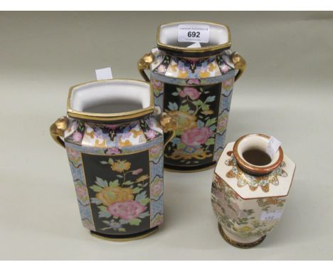 Pair of Noritake rectangular porcelain vases with elephant head side handles and all-over floral decoration on black ground, 