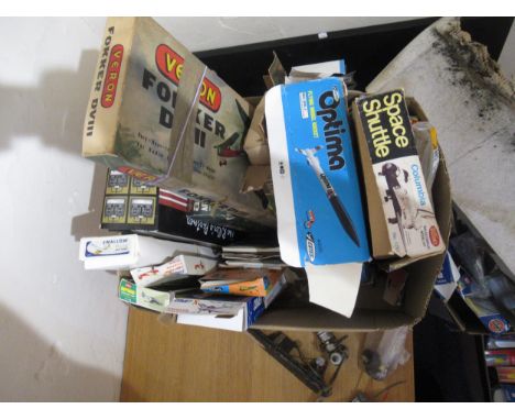 Box containing a collection of various flying scale model kits, unbuilt, with two radio control units, four various Glow Plug