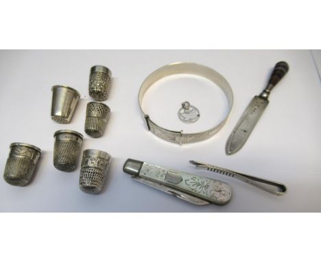 Child's silver bangle together with six silver thimbles, silver and agate bookmark, silver and mother of pearl fruit knife, t