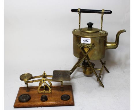 Brass spirit kettle on stand with burner, having ebonised handle, together with a pair of brass postal scales on wooden base 