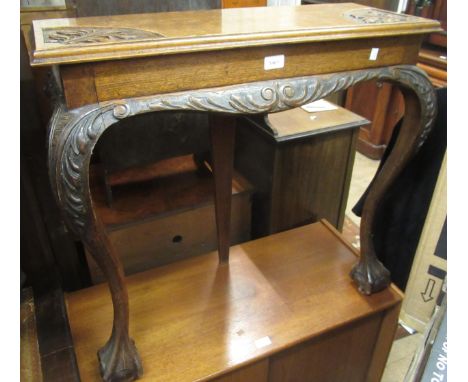 Small late Victorian oak console table with a carved top, raised on cabriole claw and ball supports, 76 x 28 x 74cm high 