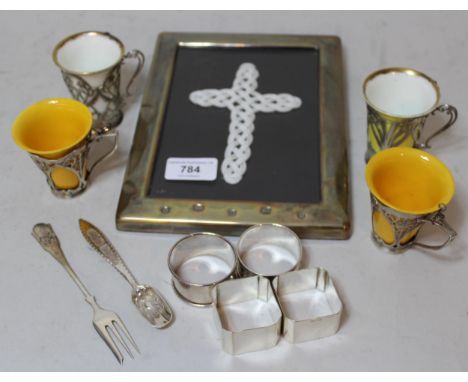 Modern silver photograph frame, four various napkin rings, Continental spoon and fork and four various coffee cans with silve