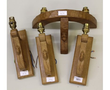 Robert ' Mouseman ' Thompson, set of three oak single branch wall sconces, together with a similar two branch wall sconceSome