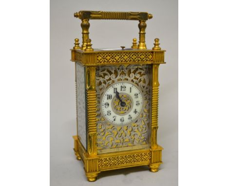 Good quality late 19th / early 20th Century gilt brass cased carriage clock with a silvered fretwork dial and sides, circular