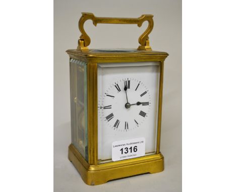 Early 20th Century French gilt brass carriage clock, the enamel dial with Roman numerals, with a two train movement striking 