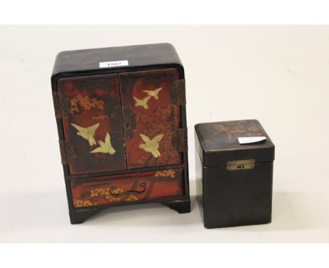 Japanese black lacquered table top cabinet decorated with figures of birds and another similar single division tea caddy 