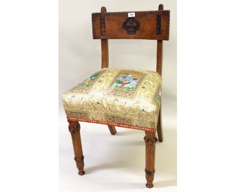 Set of three late Victorian walnut side chairs, the rail backs carved with a crown, the upholstered seats above octagonal tap