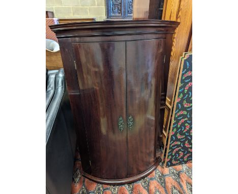 A George III mahogany bow front hanging corner cabinet, width 72cm, depth 50cm, height 109cm