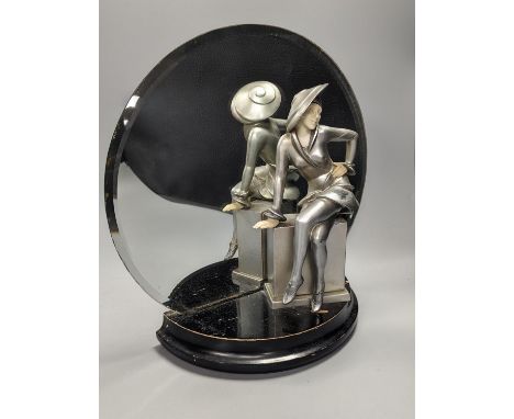 An Art Deco style patinated spelter and faux ivory figural mantel mirror, 31cm