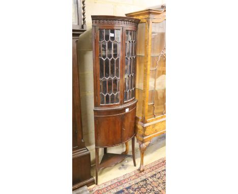 An Edwardian banded mahogany bow fronted standing corner cabinet, width 52cm, depth 38cm, height 165cm