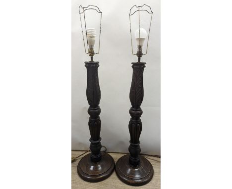 A pair of turned wood lamp bases, height 69cm excl. fitting