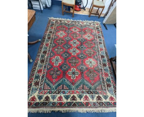 A Caucasian style red ground carpet, 286 x 210cm