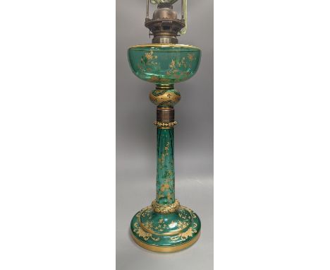 A tall Bohemian gilded green glass oil lamp, c.1900, height 48cm excl. light fitting