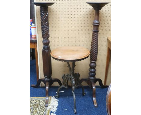 A lot comprising two assorted early 20th century circular topped jardiniere plant stands with carved pedestals on tripod base