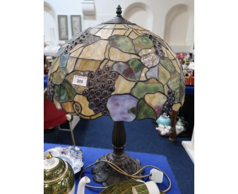 A stained and leaded glass table lamp, decorate with grapes and vine leaves Condition Report:Available upon request
