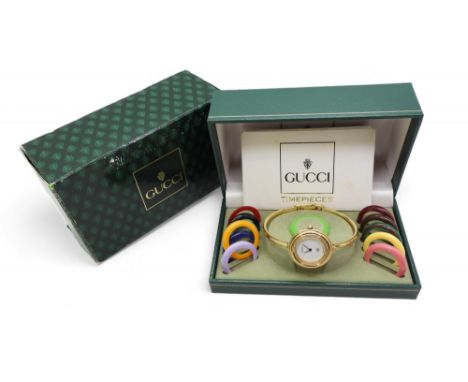 A ladies Gucci bangle watch with twelve coloured interchangeable bezels in original point of sale boxes Condition Report:Not 