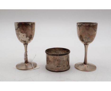 A pair of Edwardian miniature silver goblets, by&nbsp;Horace Woodward, London 1903, and a silver napkin ring, 112gms (3) Cond