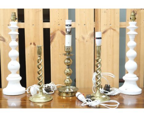 A lot comprising a pair of brass spiral candle sticks converted to table lamps, another brass table lamp and a pair of white 