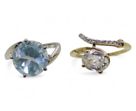 A 9ct white gold blue topaz and diamond accent ring size K, together with a 9ct gold clear zircon ring, size M, weight combin