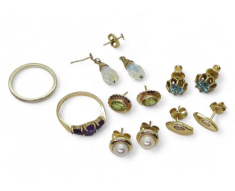 A 9ct white gold wedding ring, size K1/2, a 9ct amethyst ring, size K, and five pairs of 9ct and yellow metal earrings to inc