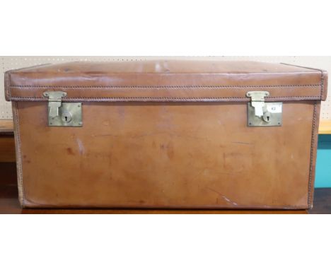 A 19th century leather travel trunk/footlocker with brass locks and twin leather carry handles,38cm high x 85cm wide x 34cm d