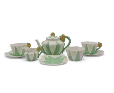 A Shelley tea for two, the handles with moulded yellow flowers and the body with ribbed detail on green and white ground, com