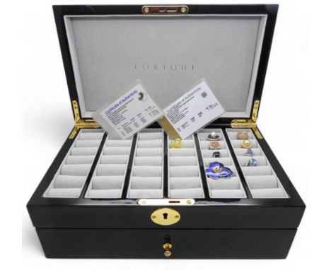 A shiny black 'Lorique' ring storage box from the GemsTV, with capacity for seventy-two rings, together with seven gem set si
