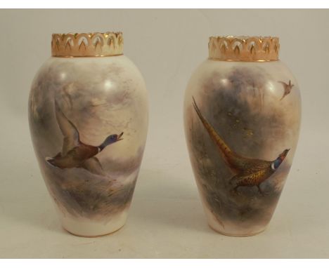 A pair of Royal Worcester vases, painted with pheasants and mallard in flight, signed Jas Stinton, shape number H682, height 