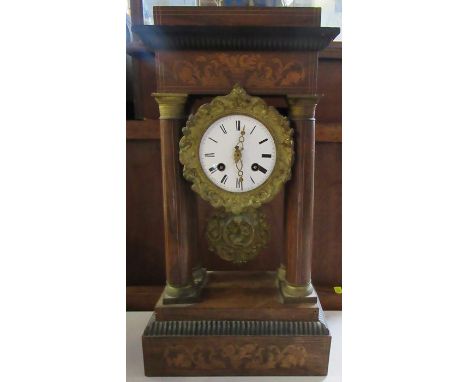 A 19th century continental mantel clock, of architectural form, with marquetry inlay and supported by four inlaid columns, he