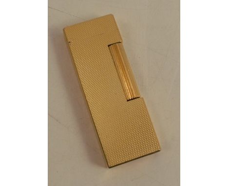 A Dunhill gold plated lighter, of rectangular form, with engine turned decoration, numbered 176689
